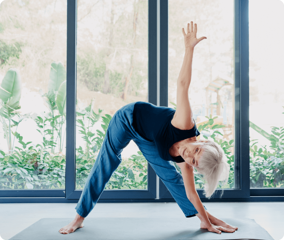 woman-stretching A woman in a room with large windows performing exercise stretches.