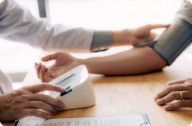 Female Doctor measuring a woman's blood pressure.