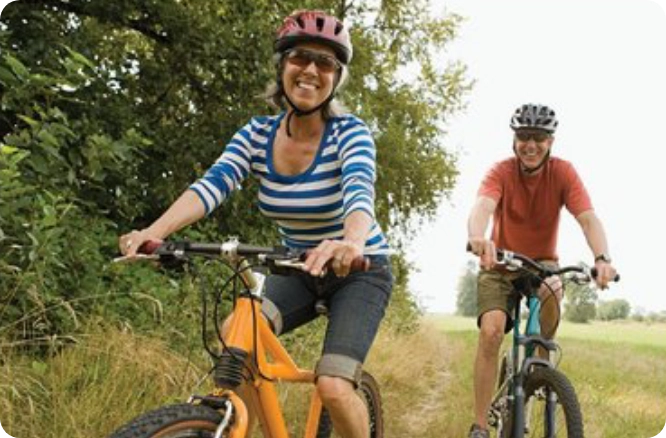 Woman and man mountain biking.