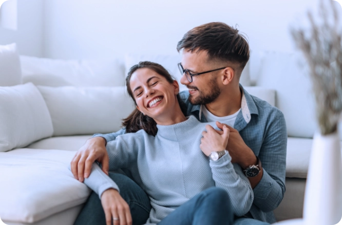 Male and female couple affectionately talking to each other in living room.