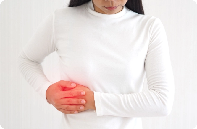 Woman holding her side as if in pain, area of pain is glowing red.