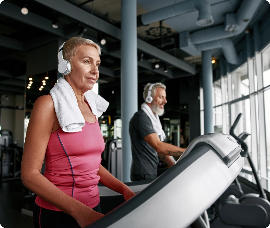 Woman and man on treadmills.