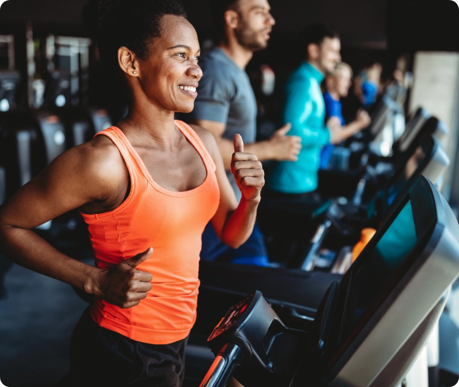 Woman running on treadmill at a gym.